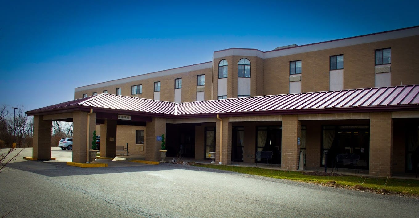 Exterior view of the facility with entrance and parking area