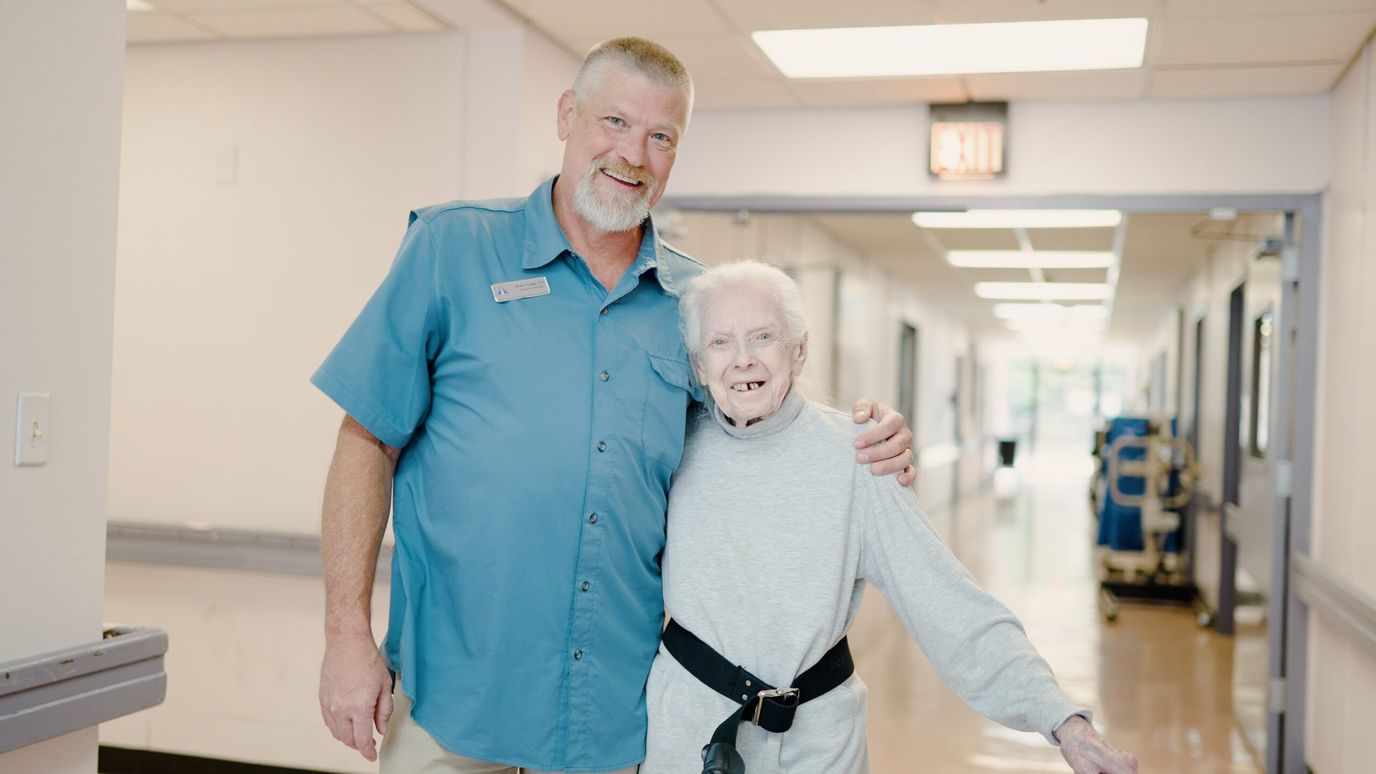 Staff member with resident in a corridor