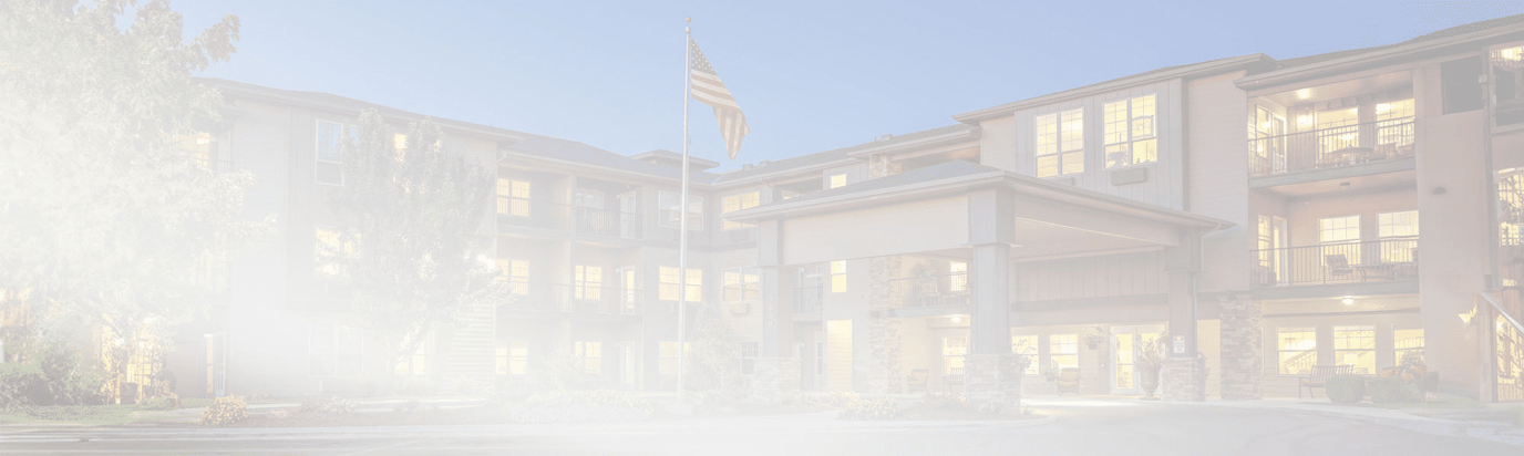 Exterior view of a senior living facility at twilight