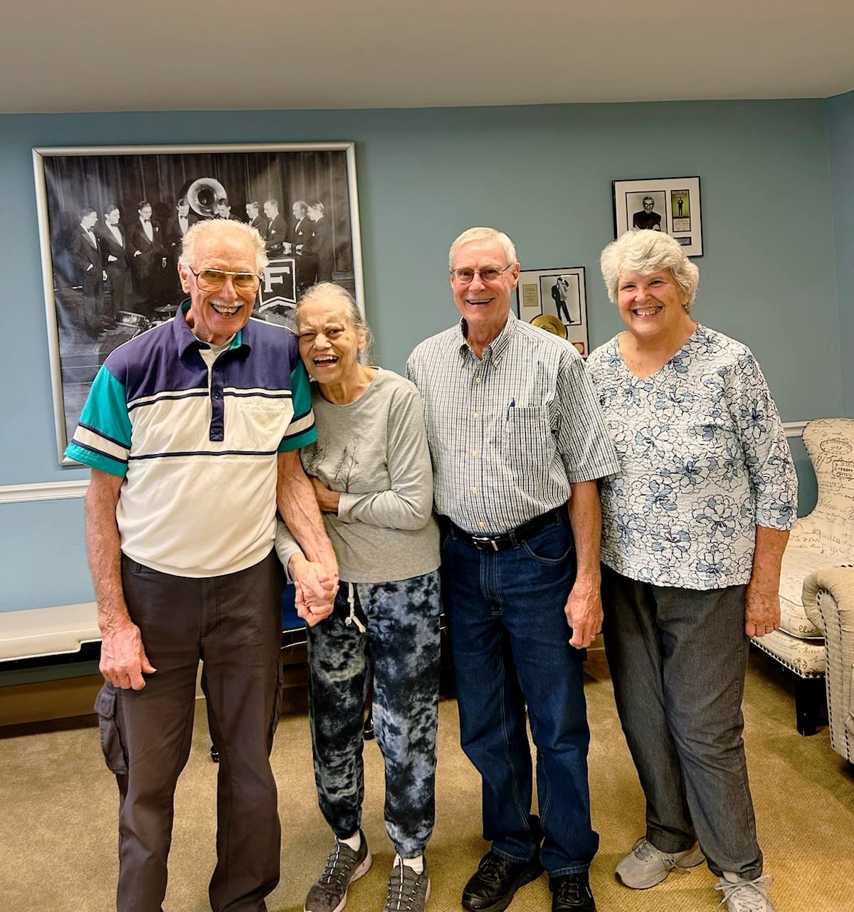 Residents and staff posing together in a common area