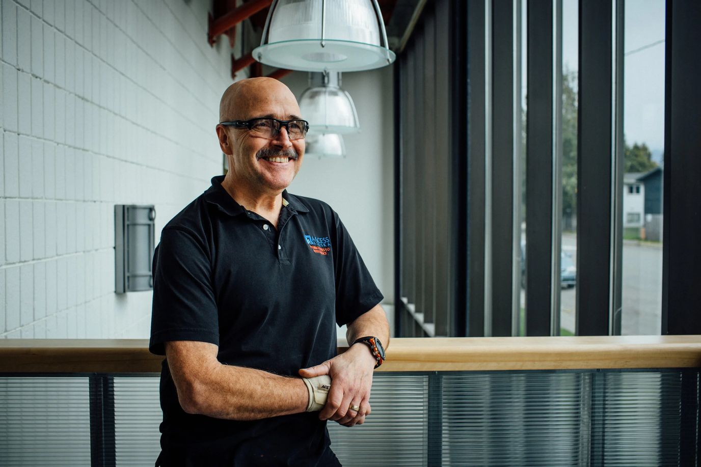 Staff member smiling in a facility interior