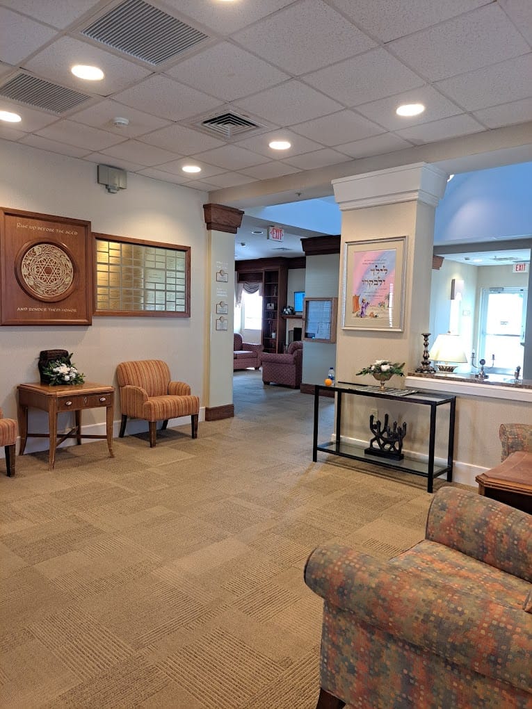 Spacious lobby with seating and decorative wall art at Capitol Rehabilitation & Healthcare Center.