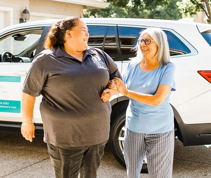Staff assisting a resident outdoors