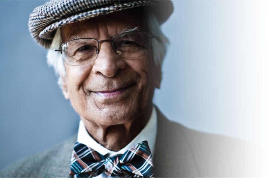 Smiling senior man wearing a bowtie and cap