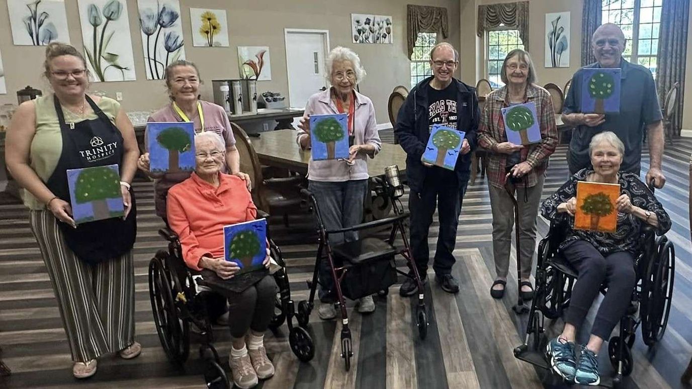 Residents participating in an art activity with staff