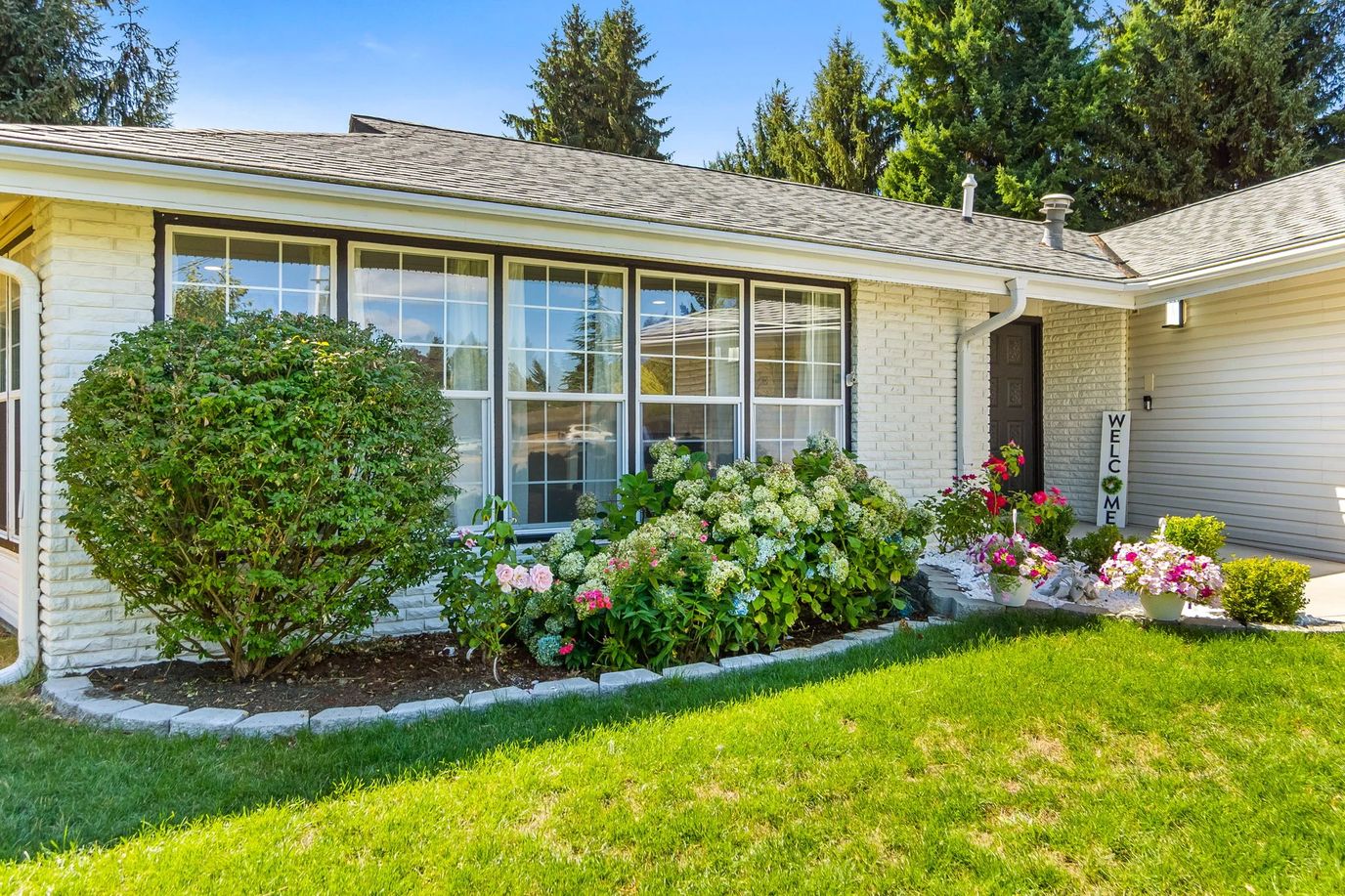 Building exterior with welcome sign and landscaped garden