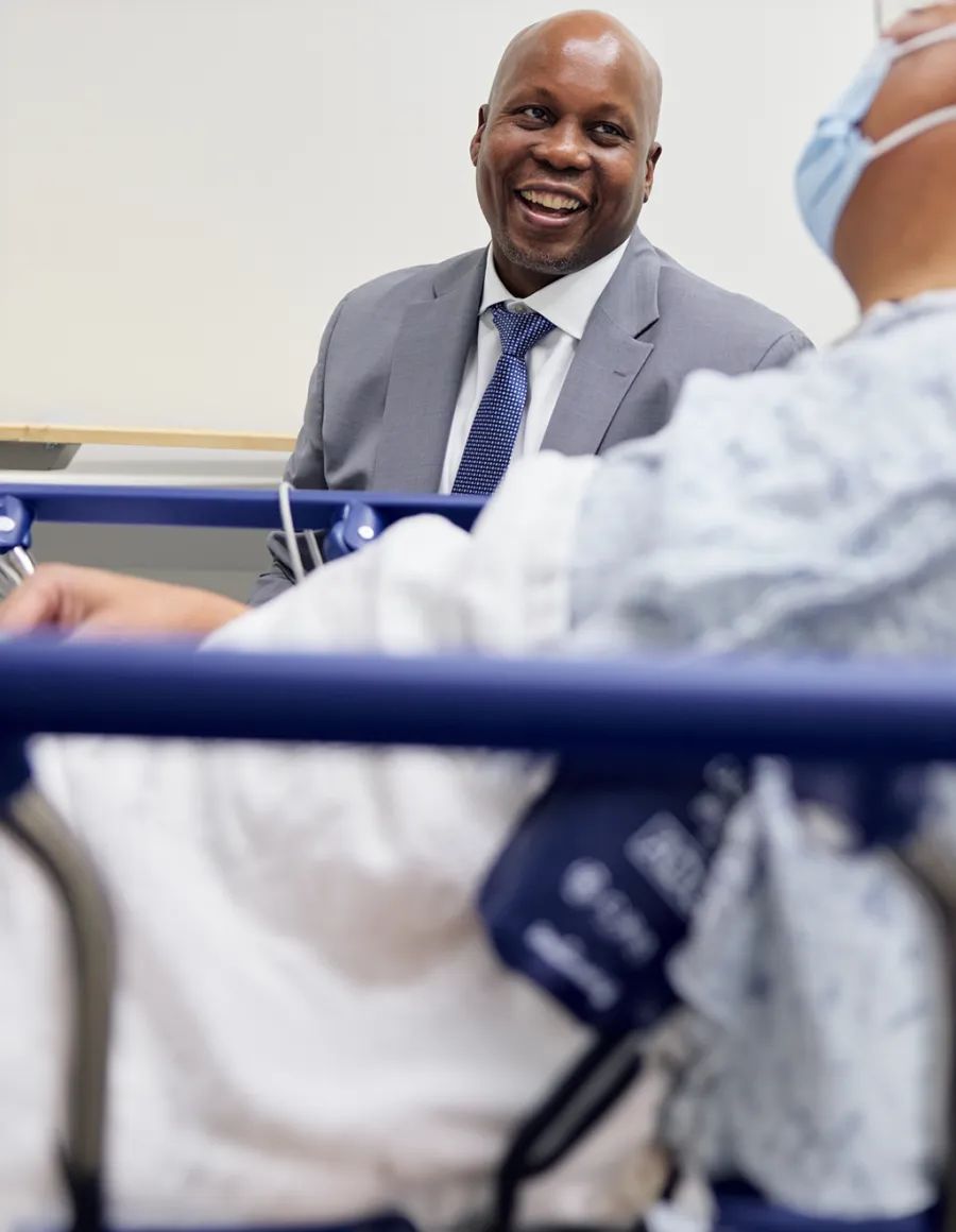 Smiling healthcare professional interacting with a patient.