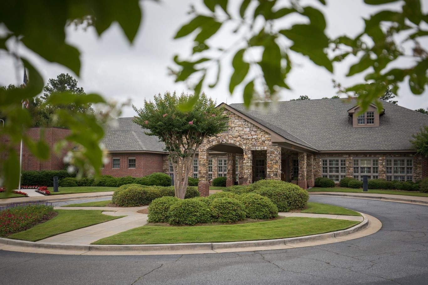 Exterior view of a senior living facility surrounded by landscaping