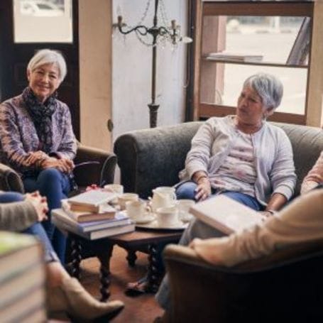 Seniors engaged in conversation in a cozy seating area