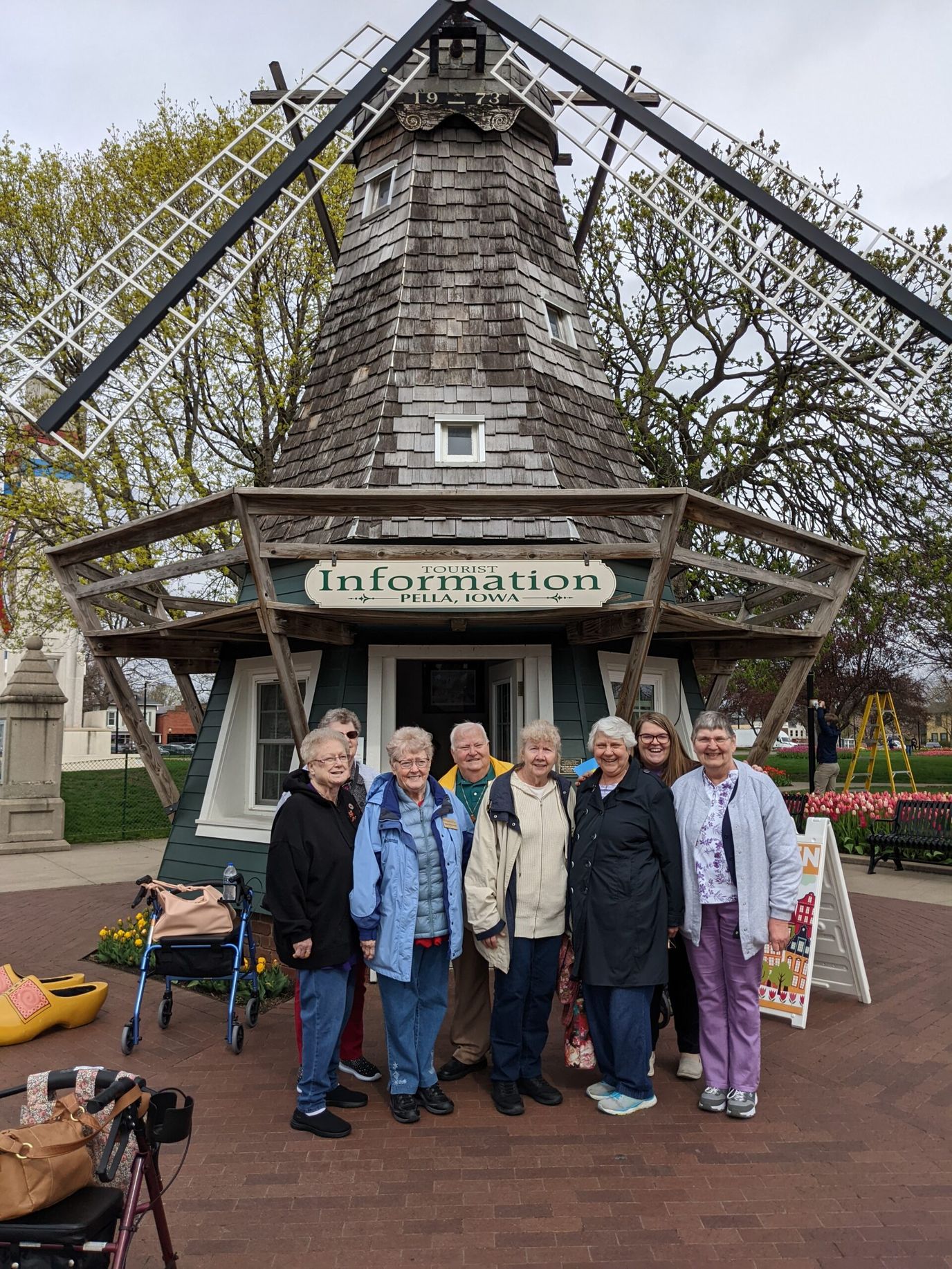 Residents posing in front of a windmill structure