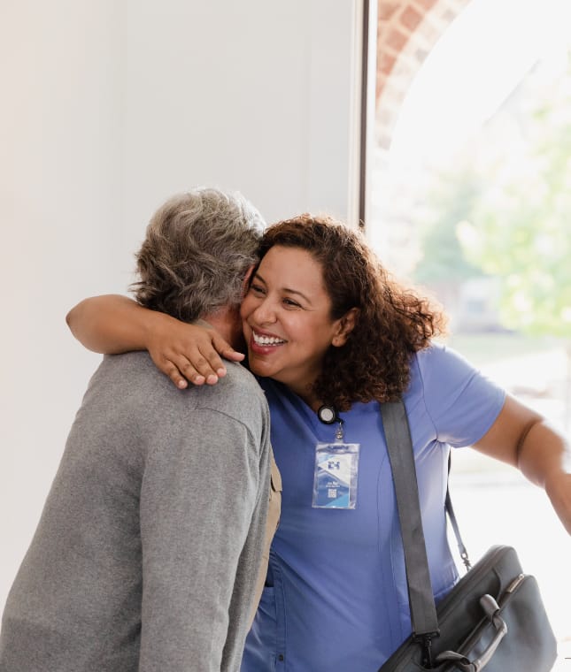Staff member joyfully greeting a resident.