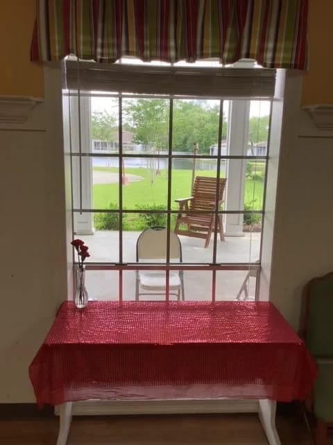 View from a window showing outdoor space with a rocking chair
