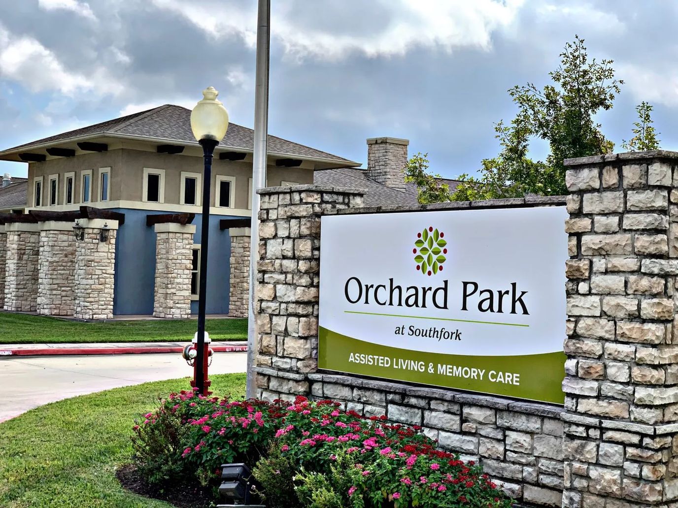 Exterior sign of Orchard Park at Southfork with landscaping