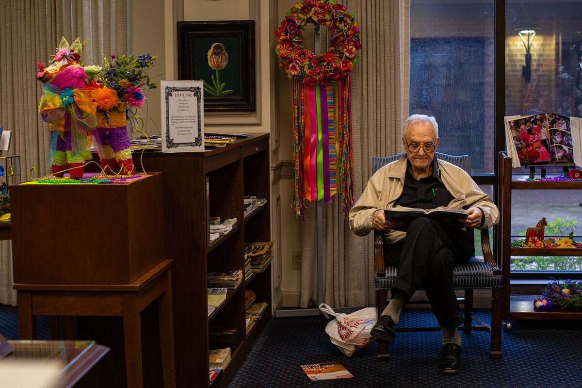 Resident reading in a common area decorated for an event