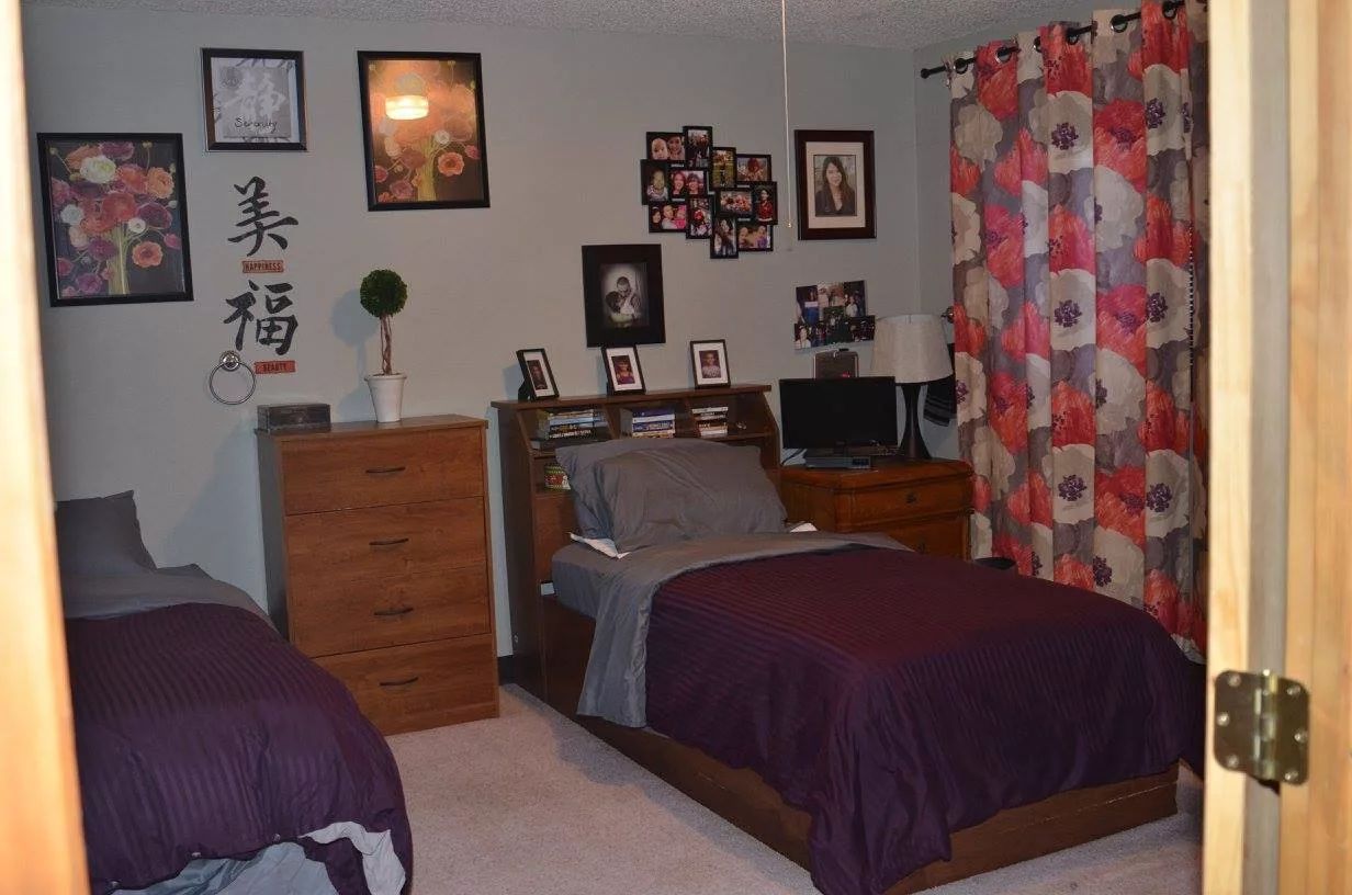 Private resident room with two beds and personal decor