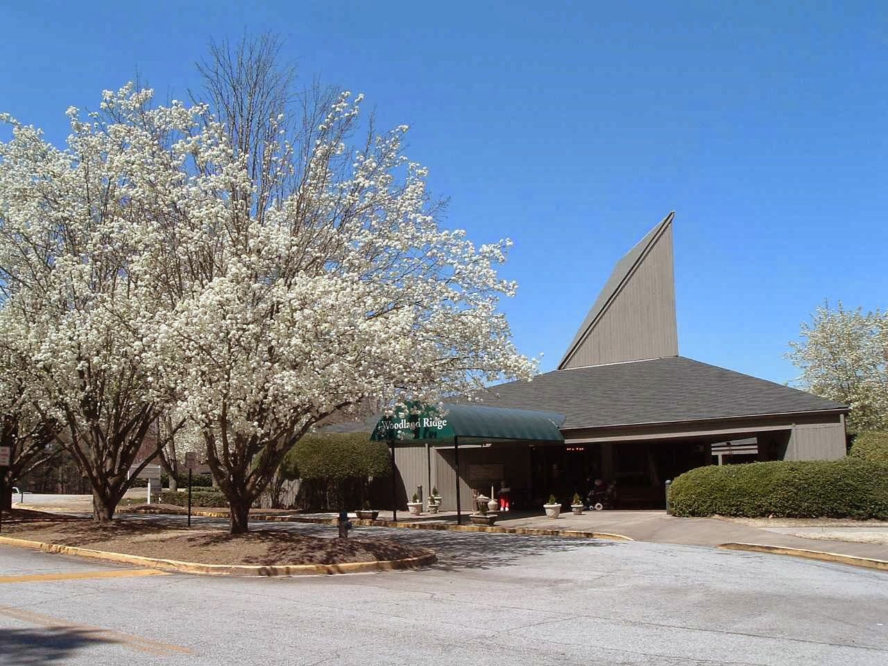 Exterior view of Woodland Ridge Assisted Living with flowering trees