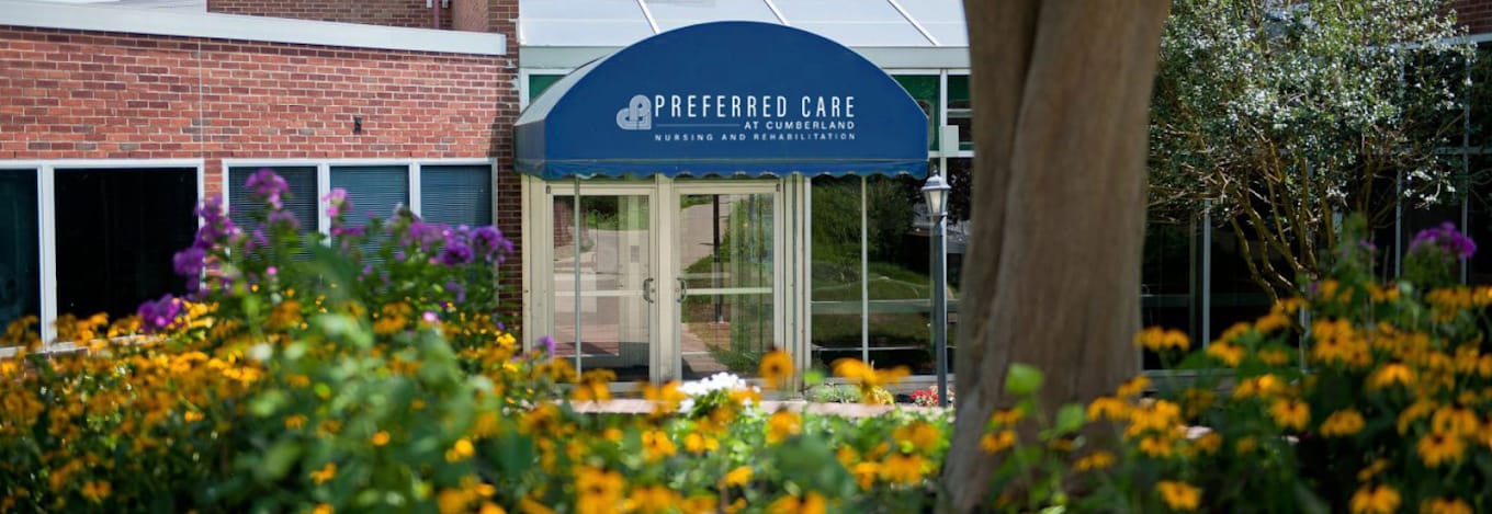 Entrance of Preferred Care at Cumberland surrounded by flowers