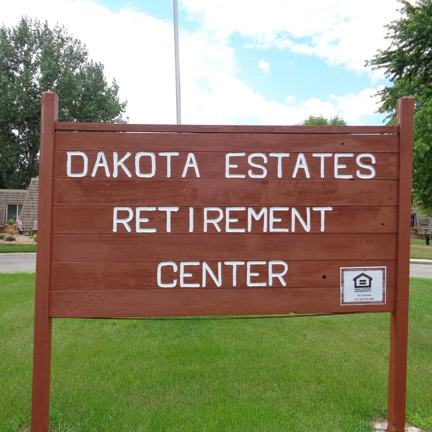 Sign for Dakota Estates Retirement Center in a green area