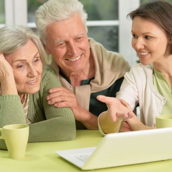 Residents and staff engaging with a laptop
