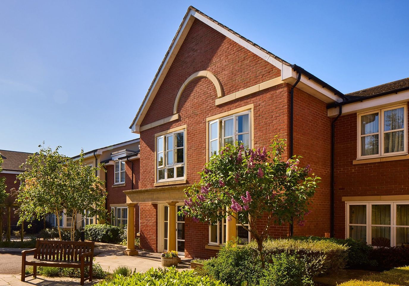 Exterior view of the facility building with gardens
