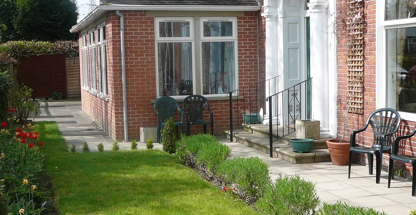Well-maintained outdoor area with garden and seating.