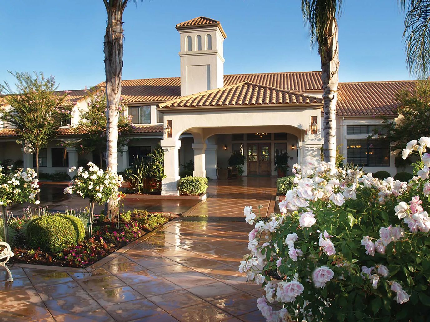 Front entrance of Oakmont of Escondido Hills with flowers