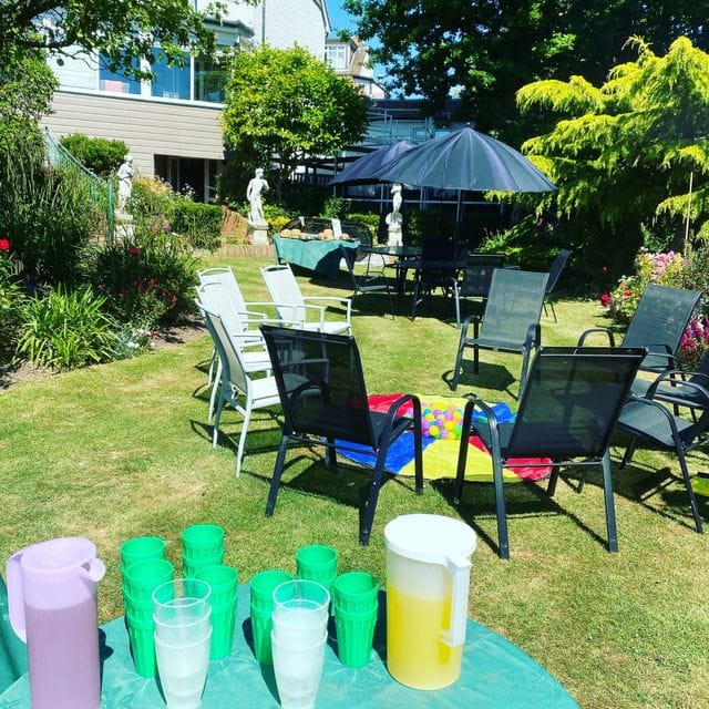 Outdoor garden space with seating and refreshment options.