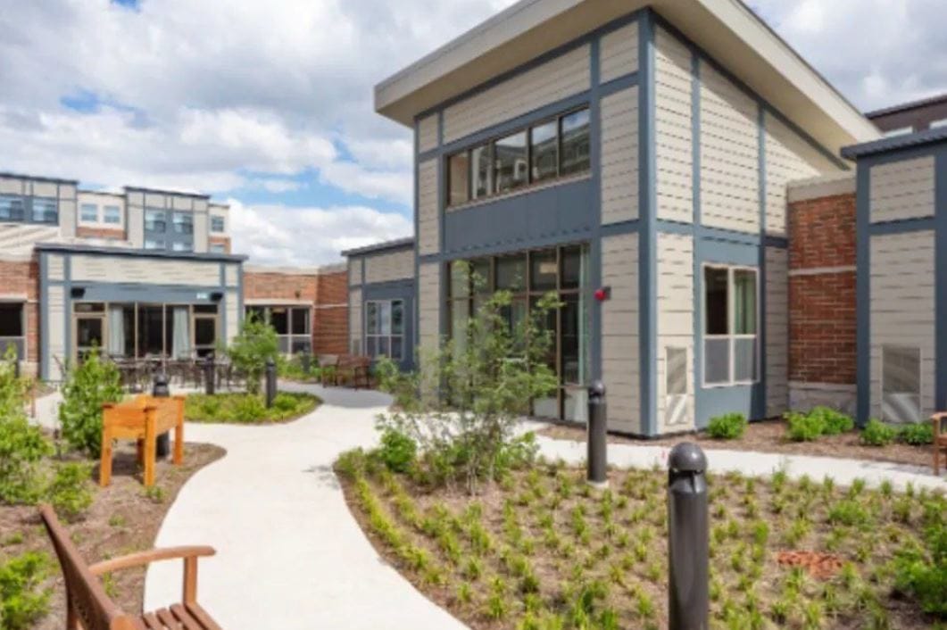 Outdoor pathway and building exterior of assisted living facility