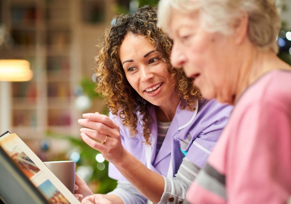 Staff member engaging with a resident during an activity