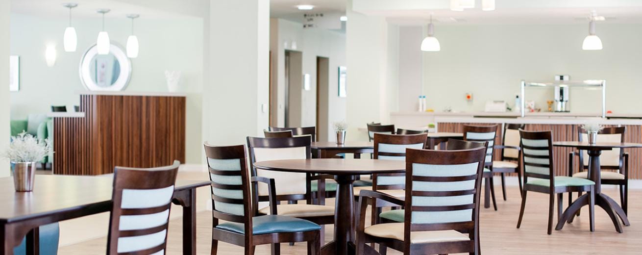 Bright dining area with wooden tables and chairs