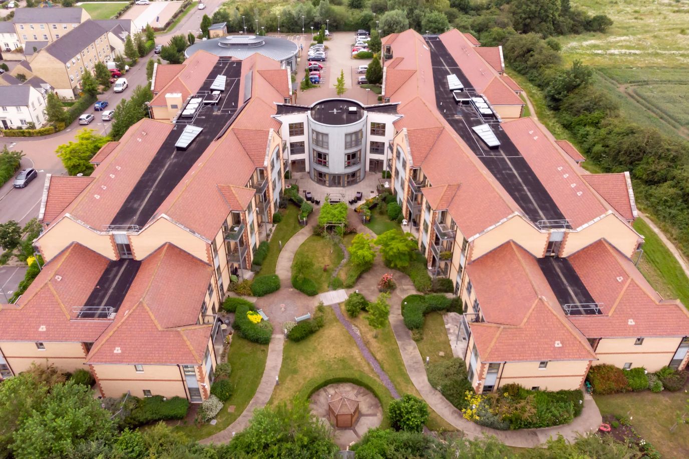 Aerial view of a senior living facility with gardens