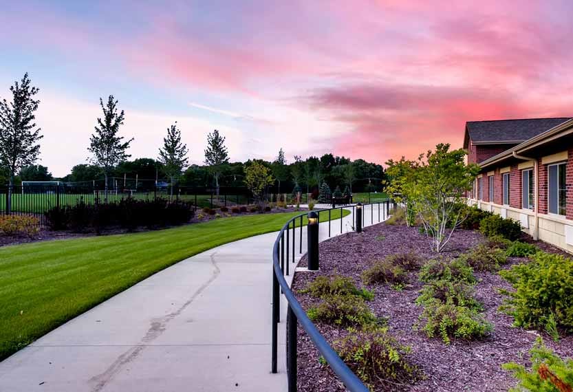 Pathway alongside the facility with landscaped gardens