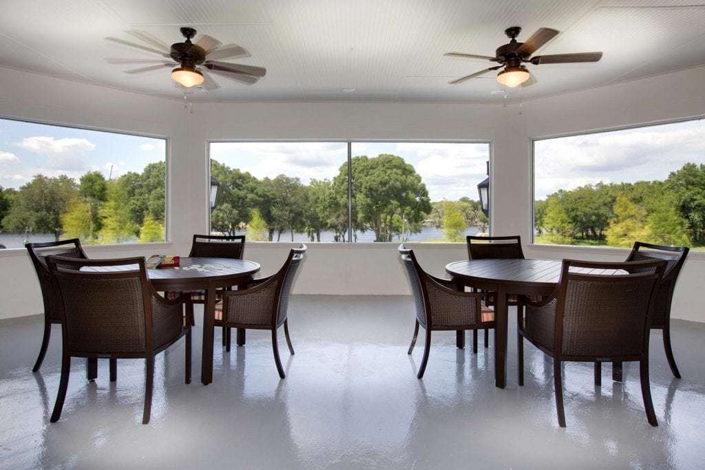 Bright common area with tables and river view