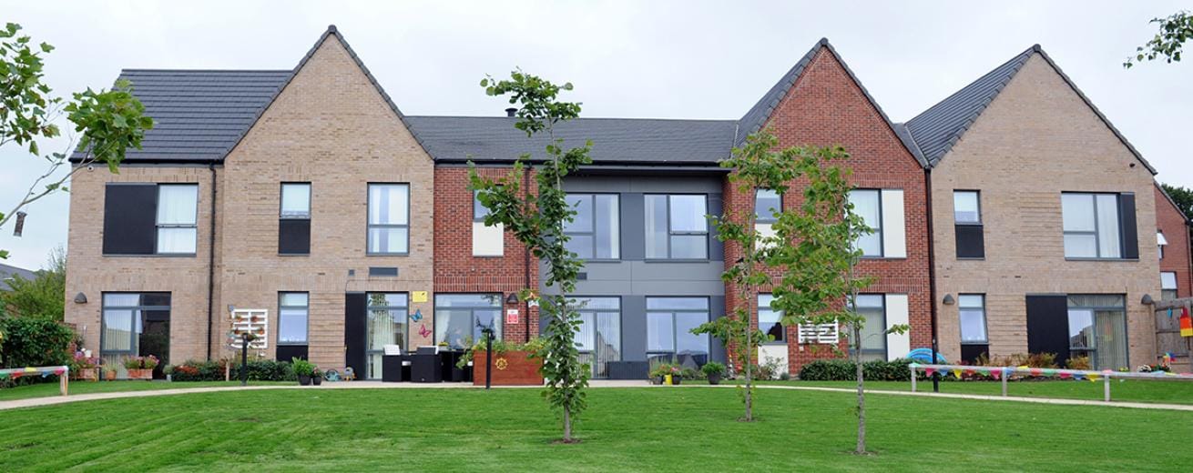 Exterior view of Oleander House with landscaped garden