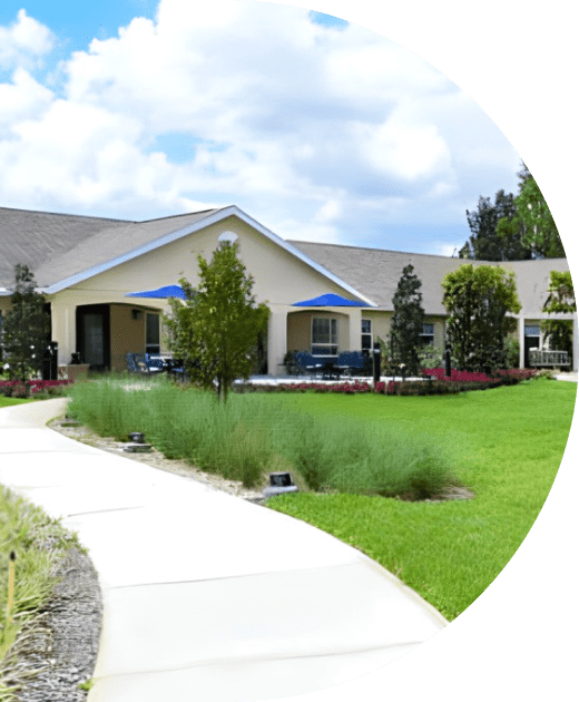 Exterior view of the senior living facility with landscaped path