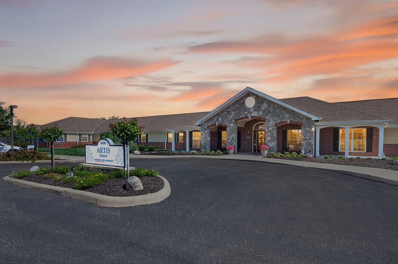 Exterior view of Artis Senior Living facility at sunset