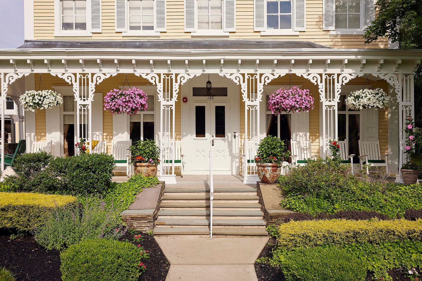Beautiful entrance of a senior living facility with colorful flowers
