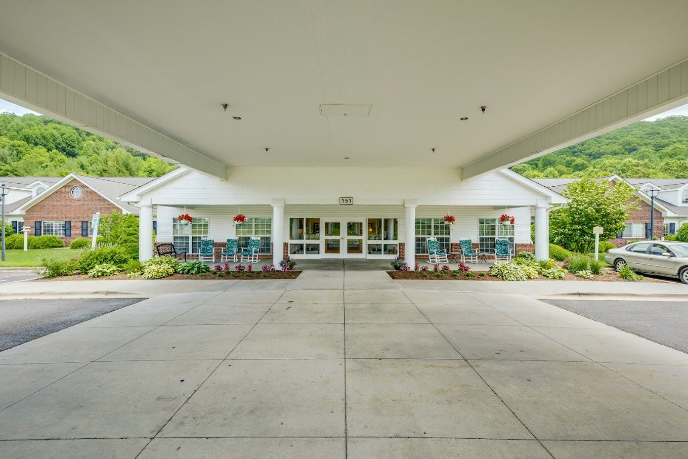 Front entrance of a senior living facility with rocking chairs