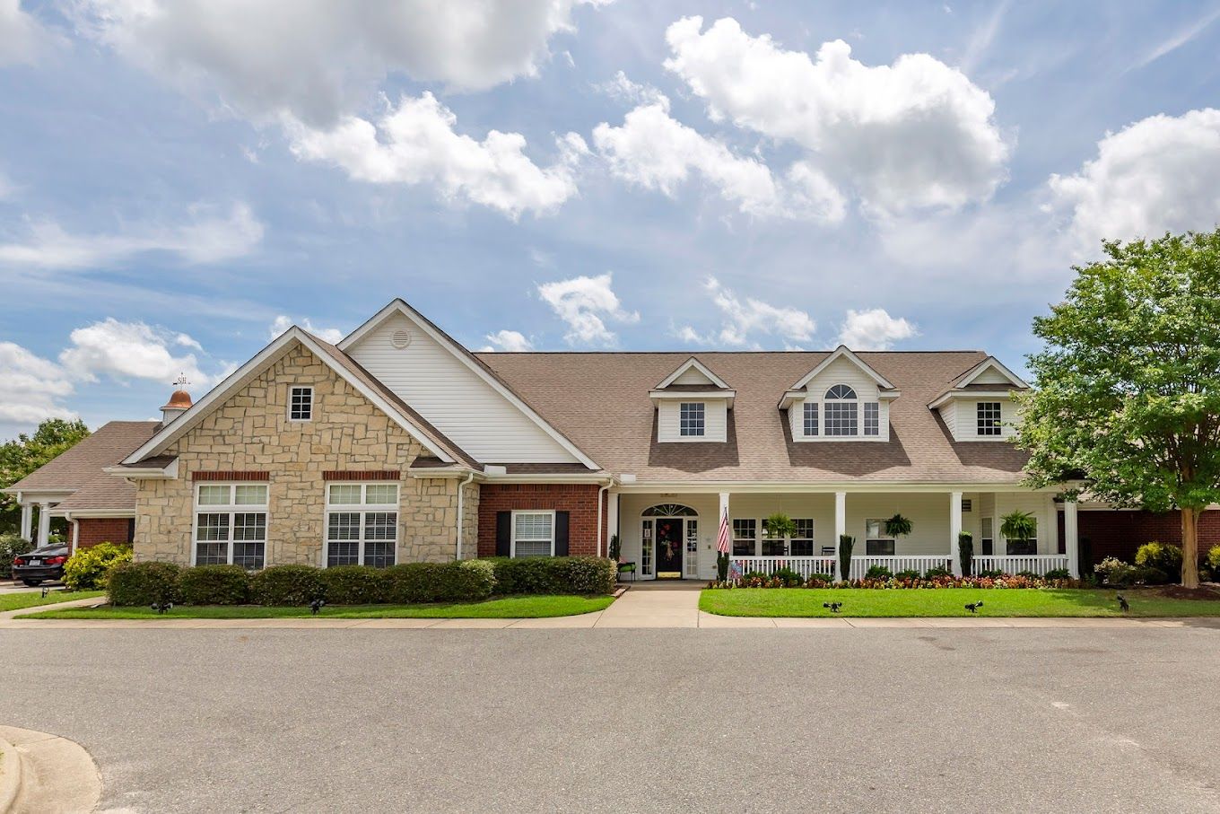 Exterior view of a senior living facility with landscaped entrance