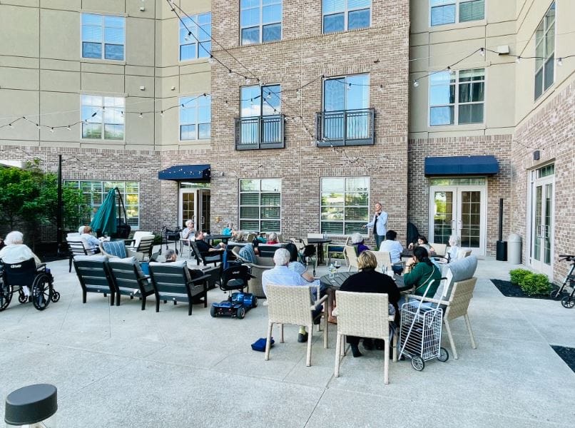 Residents enjoying an outdoor gathering by the building.