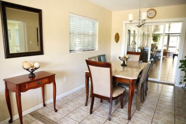 Well-lit dining room with a wooden table and chairs