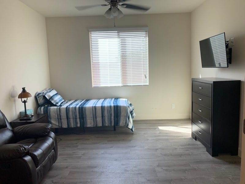 Private resident room with bed and furniture