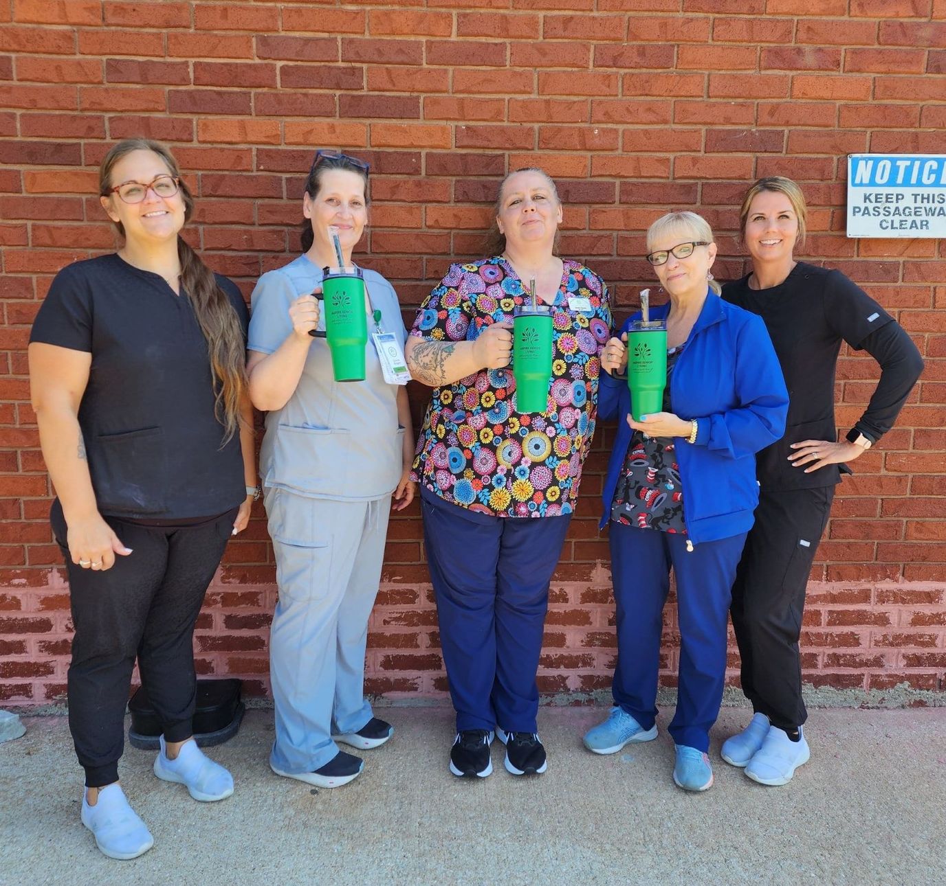 Staff members holding drinks outside the facility