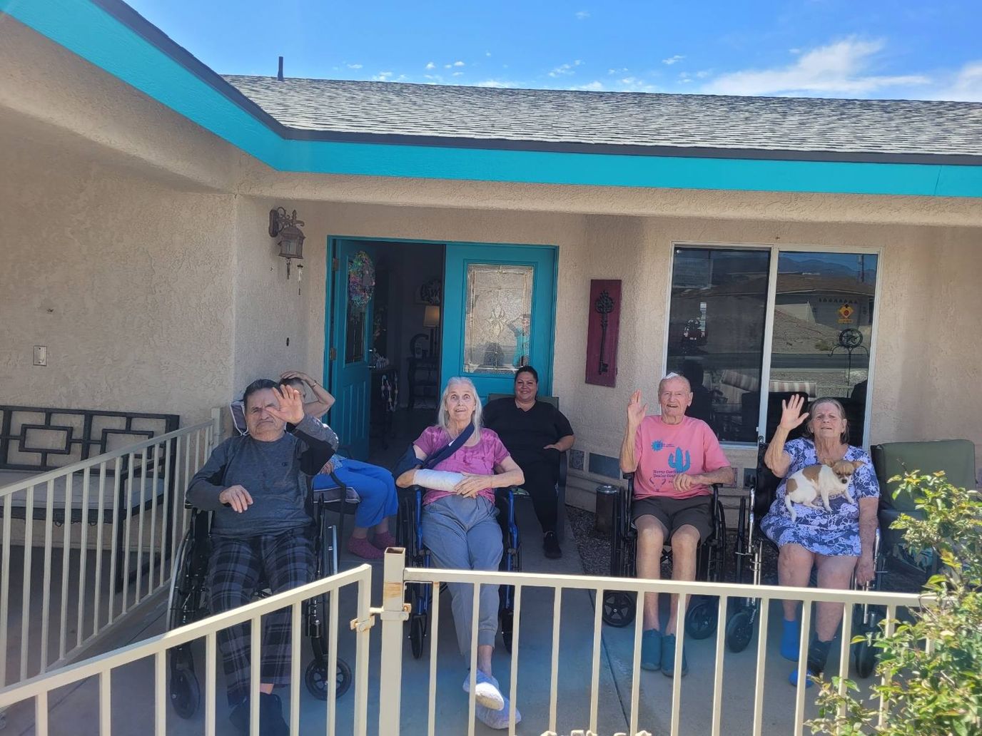 Residents waving outside the facility
