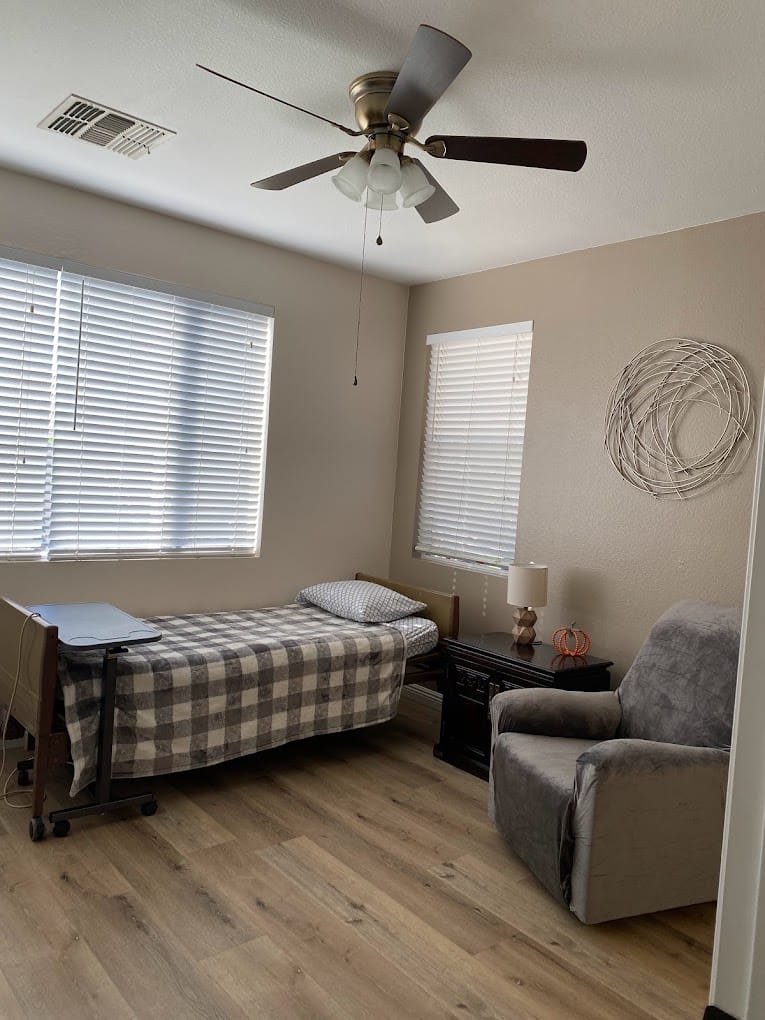 A resident room with a bed and seating area