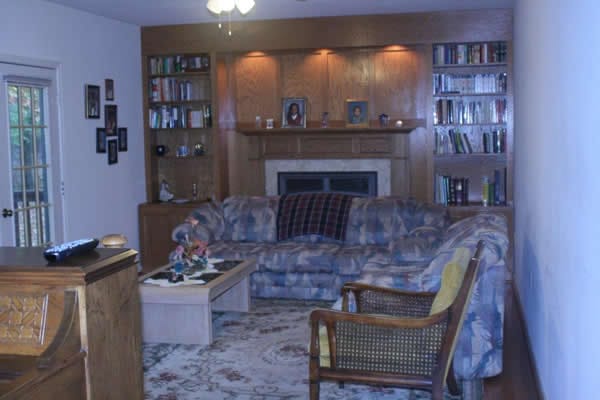 Comfortable living room with a sofa, chairs, and bookshelves