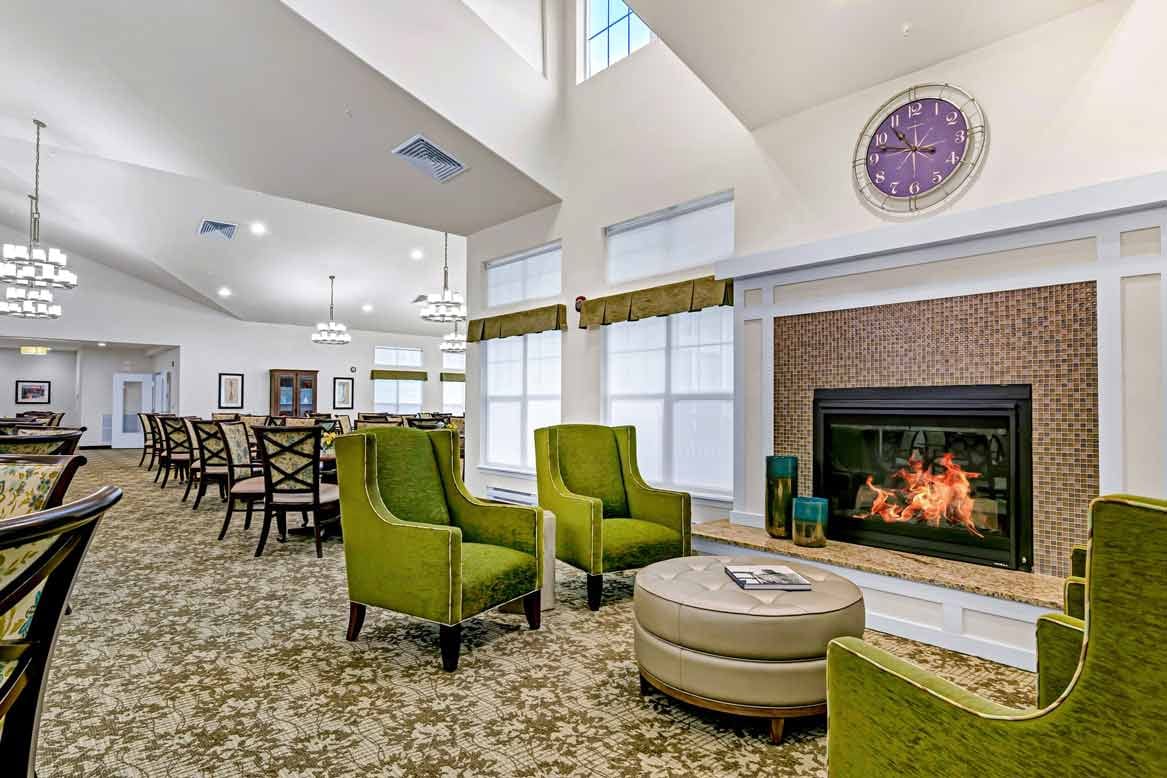 Bright common area with seating and a fireplace