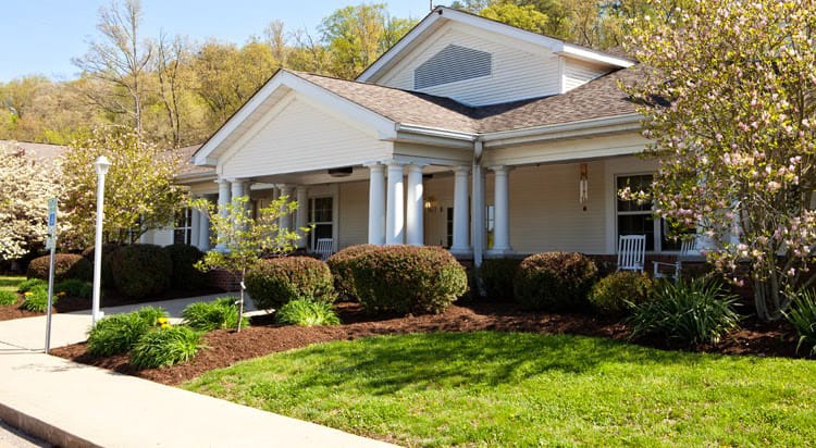 Exterior view of the assisted living facility with gardens