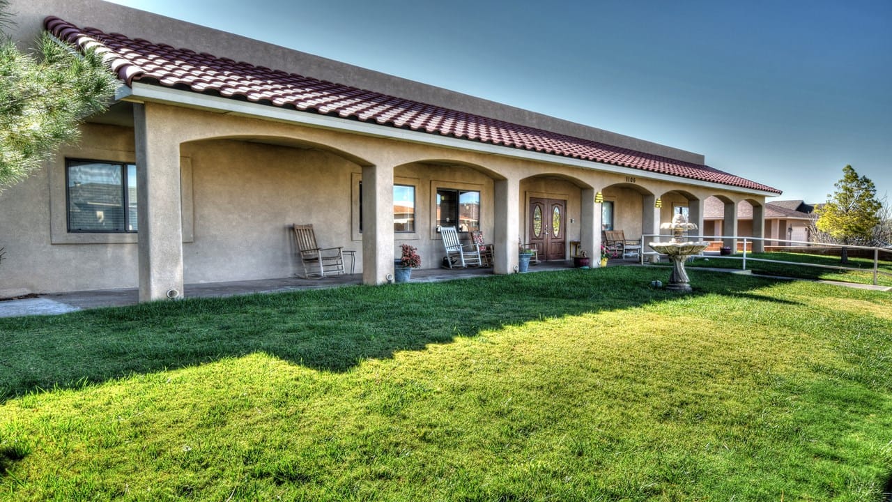 Exterior view of the assisted living facility with outdoor seating