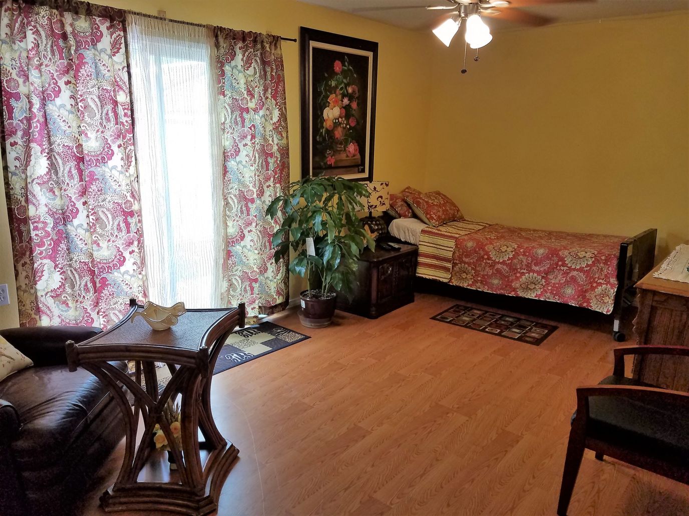 Cozy resident room with bed, coffee table, and plants